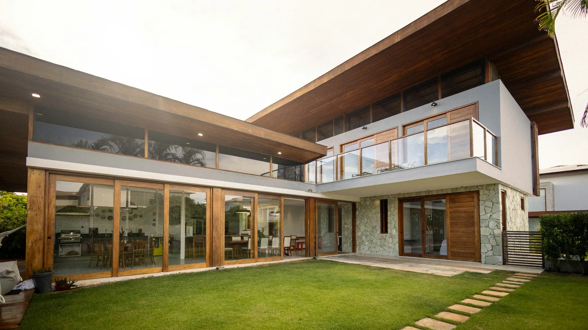 Modern house with large windows and a green lawn